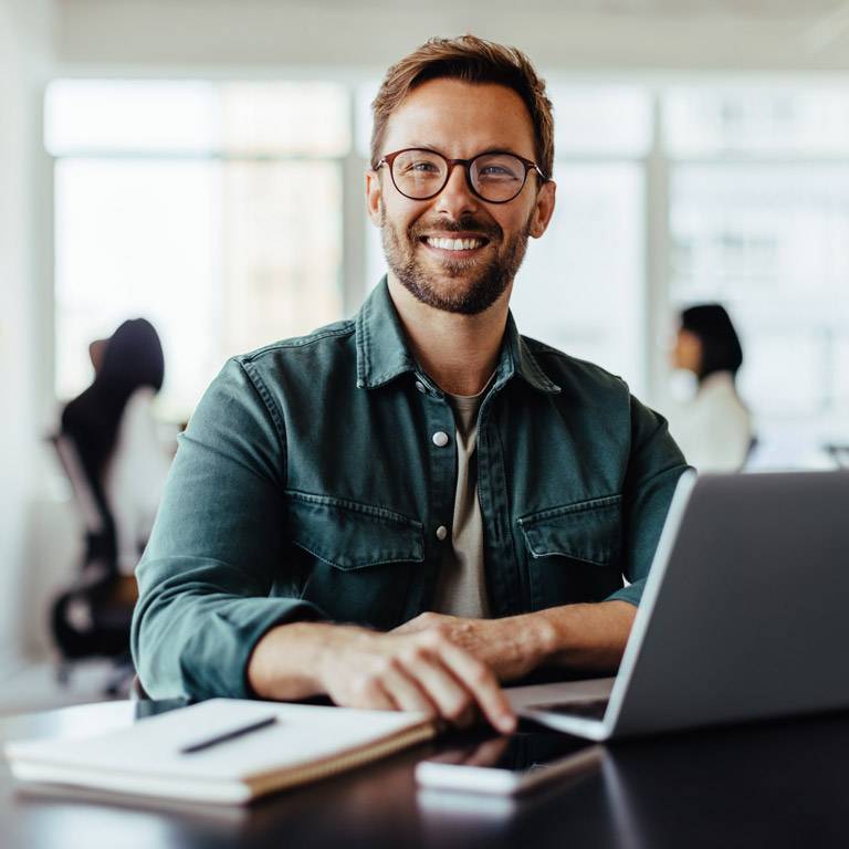 redteam projects smiling man working at laptop with notebook